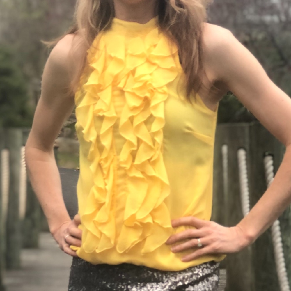 Yellow ruffled sleeveless high-necked shirt